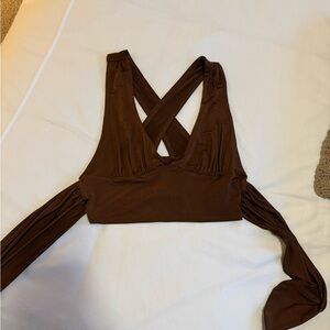 brown cute tie top from urban outfitters. cross straps with a cute tie in back